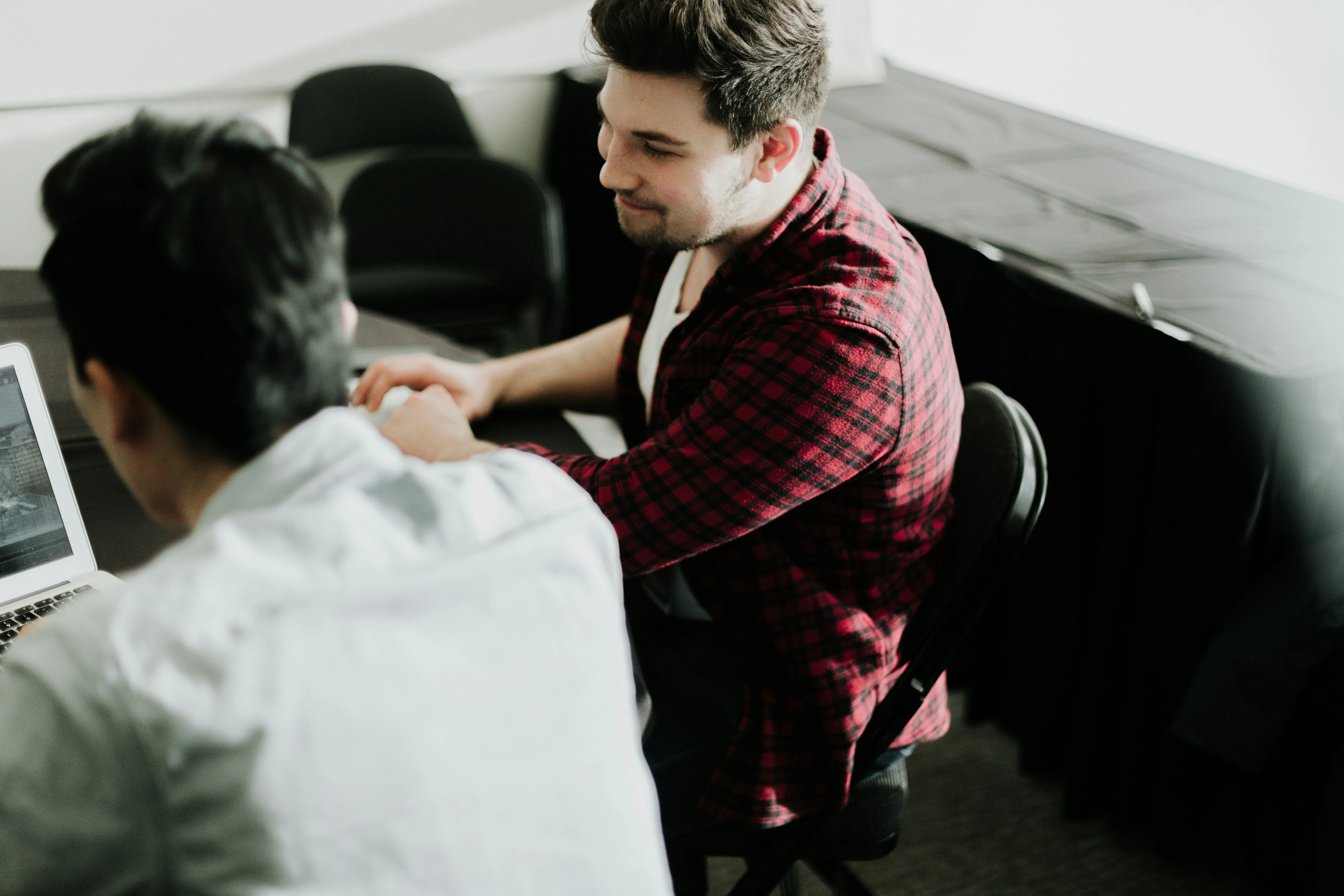 Two colleagues shaking hands after a consultation